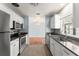 Open kitchen with stainless appliances and view into adjacent living area at 439 Sunrise Ct, Orlando, FL 32803