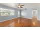 Bright living room featuring gleaming hardwood floors, ceiling fan, and front door at 439 Sunrise Ct, Orlando, FL 32803