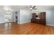 Open living area featuring beautiful wood floors, a ceiling fan, and a built-in cabinet at 439 Sunrise Ct, Orlando, FL 32803