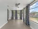 Inviting sunroom with tiled floors, natural light, and decorative curtains at 439 Sunrise Ct, Orlando, FL 32803