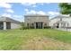 Expansive backyard includes a screened-in patio and well-manicured landscaping, ideal for outdoor enjoyment at 488 Kistler Cir, Clermont, FL 34715