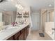 Bathroom with double vanity, walk-in shower, and a soaking tub at 488 Kistler Cir, Clermont, FL 34715