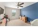 Bright bedroom with blue accent wall, window, and ample floor space at 488 Kistler Cir, Clermont, FL 34715