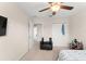 Comfortable bedroom featuring neutral walls, ceiling fan, and a relaxing chair at 488 Kistler Cir, Clermont, FL 34715