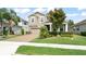 Charming two-story home features a well-manicured front yard and a brick driveway at 488 Kistler Cir, Clermont, FL 34715