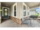Inviting front porch features brick flooring, stone accents and comfortable seating area at 488 Kistler Cir, Clermont, FL 34715