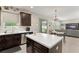 An open-concept kitchen with a center island leading into a living area at 488 Kistler Cir, Clermont, FL 34715