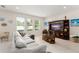 Spacious living room with large windows and cozy gray sectional sofa at 488 Kistler Cir, Clermont, FL 34715