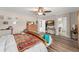 Bedroom with wood-look floors, a ceiling fan, and an ensuite bathroom at 488 Kistler Cir, Clermont, FL 34715