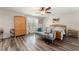Bedroom with wood floors, a ceiling fan, and a decorative sitting bench at 488 Kistler Cir, Clermont, FL 34715