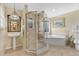 Modern bathroom boasting a glass shower, soaking tub, pedestal sink, and tiled walls at 518 Glen Grove Ln, Orlando, FL 32839