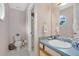Charming bathroom featuring patterned wallpaper, a large mirror, and a classic sink design at 518 Glen Grove Ln, Orlando, FL 32839