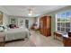 Bedroom boasting a large bed, classic furniture, and double doors that lead to an outdoor patio at 518 Glen Grove Ln, Orlando, FL 32839