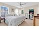 Comfortable bedroom with soft natural light, featuring a ceiling fan, neutral tones, and simple furnishings at 518 Glen Grove Ln, Orlando, FL 32839