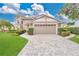 Charming home featuring a manicured lawn, brick paved driveway, and a two-car garage at 518 Glen Grove Ln, Orlando, FL 32839
