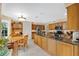 Spacious kitchen with wooden cabinetry, stainless appliances, and a center island with bar seating at 518 Glen Grove Ln, Orlando, FL 32839