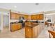 Well-equipped kitchen featuring a center island, stainless steel appliances, and wooden cabinets at 518 Glen Grove Ln, Orlando, FL 32839