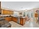 Bright kitchen featuring wooden cabinetry, stainless steel appliances, granite countertops, and adjacent breakfast nook at 518 Glen Grove Ln, Orlando, FL 32839