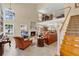 Spacious living room with a fireplace, high ceilings and open staircase to a second-floor at 518 Glen Grove Ln, Orlando, FL 32839