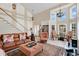 Elegant living room with tall ceilings, fireplace, open staircase and large windows at 518 Glen Grove Ln, Orlando, FL 32839