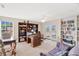 Bright office with built-in bookshelves, desk, and French doors leading to an outdoor space at 518 Glen Grove Ln, Orlando, FL 32839