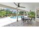 Covered patio with a dining table and chairs overlooking the screened pool area at 518 Glen Grove Ln, Orlando, FL 32839