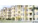 Multi-story building with balconies, white railings, and manicured landscaping at 5276 Cane Island Loop # 302, Kissimmee, FL 34746