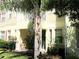 Exterior view of the building with balconies, well-maintained landscaping, and a tropical feel at 5276 Cane Island Loop # 302, Kissimmee, FL 34746