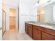 Bathroom boasts double vanity, granite countertop, glass shower, and access to the walk-in closet at 6132 Bimini Twist Loop, Orlando, FL 32819