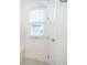 Bright bathroom featuring a window with blinds, a tiled wall, and white door, offering a clean and modern space at 6132 Bimini Twist Loop, Orlando, FL 32819