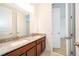Bathroom with double sinks, granite countertop, and view of an open doorway at 6132 Bimini Twist Loop, Orlando, FL 32819