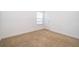 A bright bedroom featuring neutral carpet, white walls, and a window with blinds at 6132 Bimini Twist Loop, Orlando, FL 32819