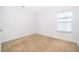 Neutral bedroom with carpet, a window letting in light, and painted in neutral colors with closet space at 6132 Bimini Twist Loop, Orlando, FL 32819