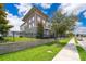 Modern townhome showing a well-manicured lawn and lush trees at 6132 Bimini Twist Loop, Orlando, FL 32819