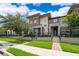 Well-kept townhomes feature symmetrical landscaping and charming entrances at 6132 Bimini Twist Loop, Orlando, FL 32819