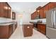 Modern kitchen boasts stainless steel appliances, ample granite counter space, and center island at 6132 Bimini Twist Loop, Orlando, FL 32819
