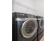 A well-equipped laundry room featuring a modern Samsung washer and dryer at 6132 Bimini Twist Loop, Orlando, FL 32819