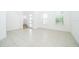 Bright living room features tile flooring, staircase and large windows, offering abundant natural light at 6132 Bimini Twist Loop, Orlando, FL 32819