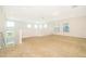 A spacious loft area with neutral carpet and natural light from multiple windows at 6132 Bimini Twist Loop, Orlando, FL 32819