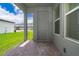 View of the covered patio with a brick floor and an exterior door at 6132 Bimini Twist Loop, Orlando, FL 32819