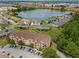 Overhead view of a condo building and surrounding community near a lake with lush green trees and lawns at 621 Terrace Ridge Cir # 621, Davenport, FL 33896