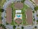 Aerial shot of condo buildings surrounding a pool, clubhouse and parking in a circular layout with grassy areas at 621 Terrace Ridge Cir # 621, Davenport, FL 33896
