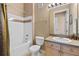 Cozy bathroom showcasing a vanity sink, toilet, and shower-tub combo at 621 Terrace Ridge Cir # 621, Davenport, FL 33896