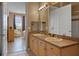 Bright bathroom features a double sink vanity and a doorway leading to the bedroom at 621 Terrace Ridge Cir # 621, Davenport, FL 33896