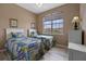 Bright bedroom featuring two twin beds, wood floors, and a large window at 621 Terrace Ridge Cir # 621, Davenport, FL 33896