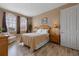 Inviting bedroom boasts wood-look flooring, light-colored walls, and natural light from large windows at 621 Terrace Ridge Cir # 621, Davenport, FL 33896
