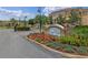 Welcoming entrance sign surrounded by colorful flowers enhances the community's curb appeal at 621 Terrace Ridge Cir # 621, Davenport, FL 33896