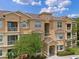 Charming multi-story condo showcases an elegant exterior with balconies and meticulously kept landscaping at 621 Terrace Ridge Cir # 621, Davenport, FL 33896