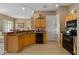 Spacious kitchen with black appliances, wood cabinets, and lots of counter space at 621 Terrace Ridge Cir # 621, Davenport, FL 33896