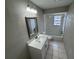 This bathroom features a tub, a vanity with white cabinets, a white countertop, and a framed mirror at 6624 Kristin Ct, Orlando, FL 32818
